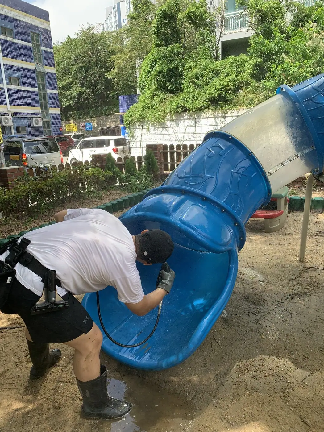 조형물 아래쪽으로 몸을 낮춰 하부 상태를 확인하며 작업하는 장면